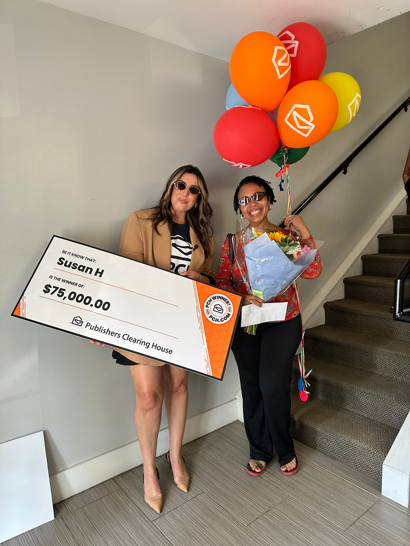 Kathleen P. holding her $1,000,000 SuperPrize check